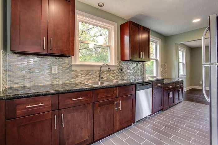 Warm wood kitchen cabinetry with a tiled backsplash and generous counter space