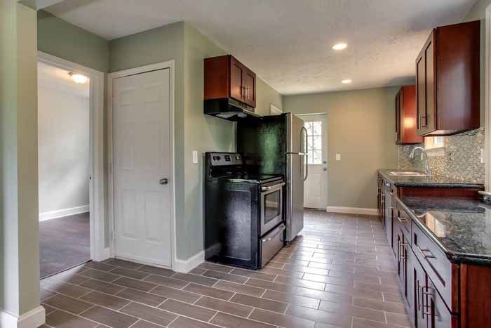 Kitchen with wood cabinets, granite counters and a window above the sink